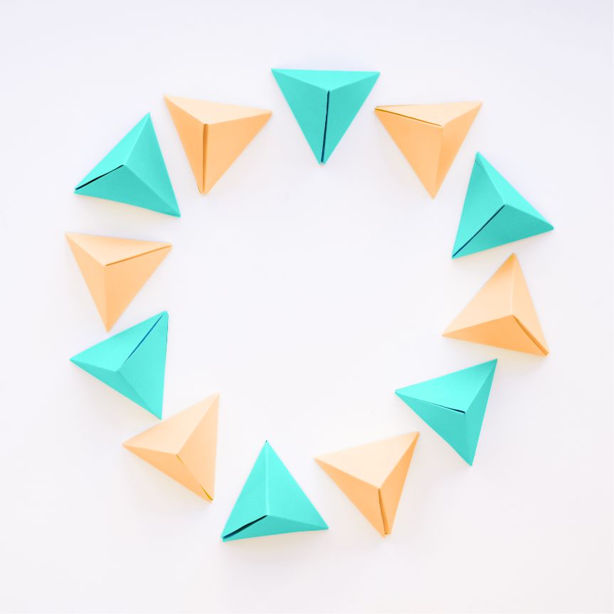 Colorful paper triangles arranged in a circle, symbolizing creativity at a Creative Thinking Retreat.